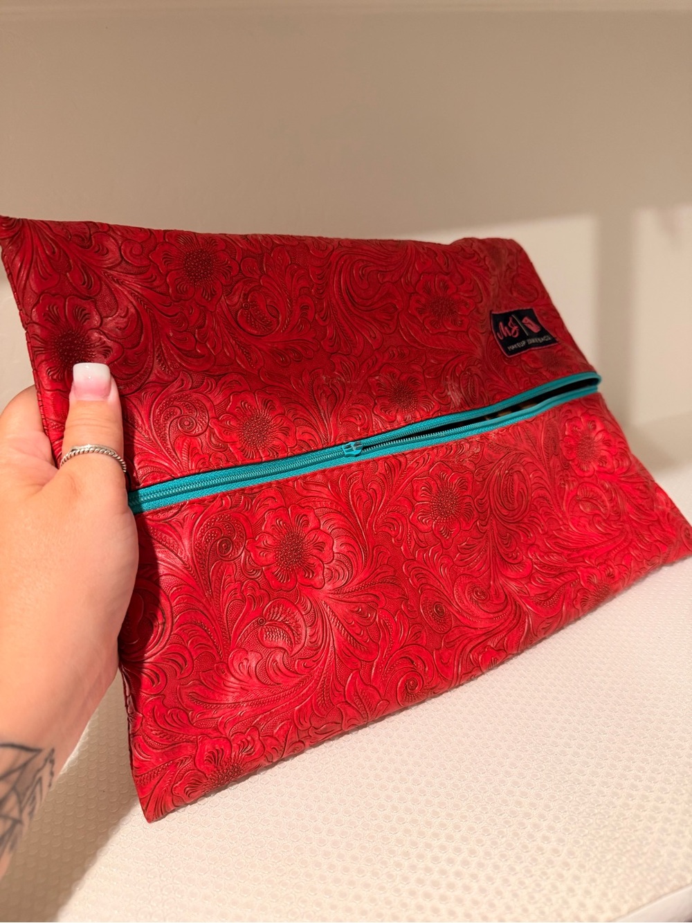 Makeup junkie medium Red Floral Tooled Clutch with Teal Zipper